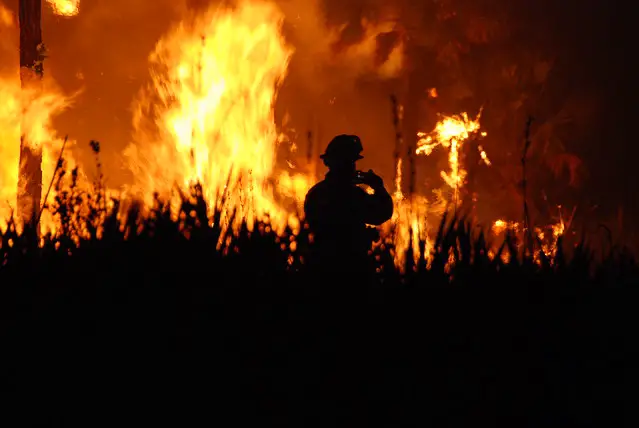 Fireman in front of a wildfire