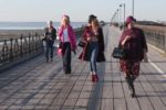 women on pier practising for fashion show