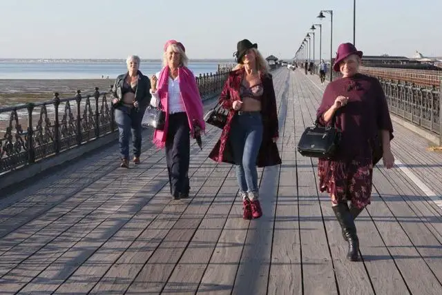 women on pier practising for fashion show