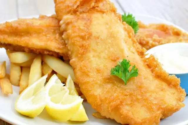 fish and chips on a plate with lemon