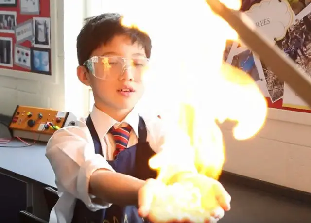 Pupil taking part in science experience in Junior School