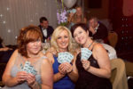 three women with raffle tickets at the event