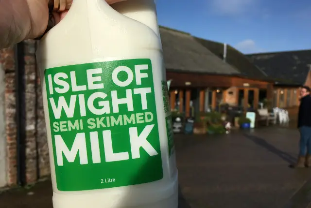 Carton of Isle of Wight being held outside briddlesford farm