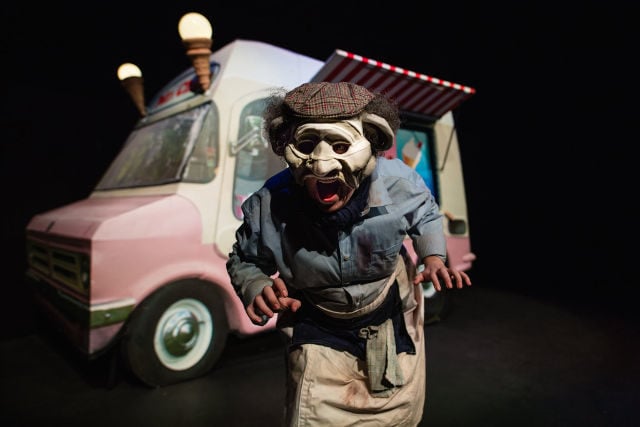 Actor wearing a mask and standing by ice cream van