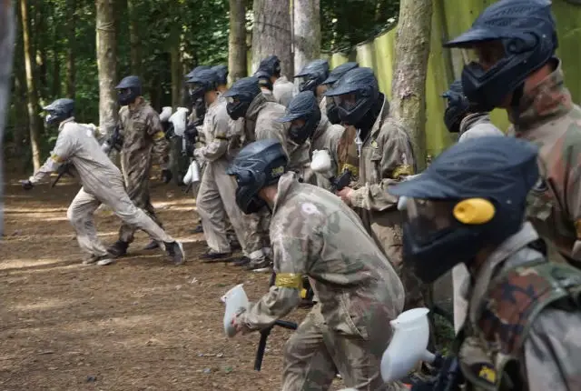Young people taking part in paintballing