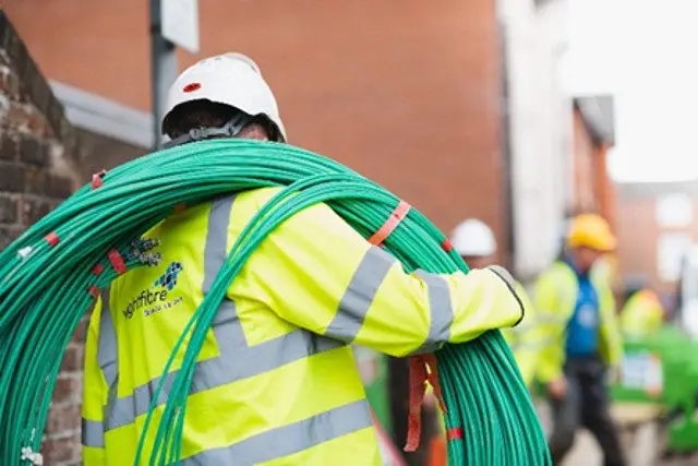 wightfibre workmen carrying cable
