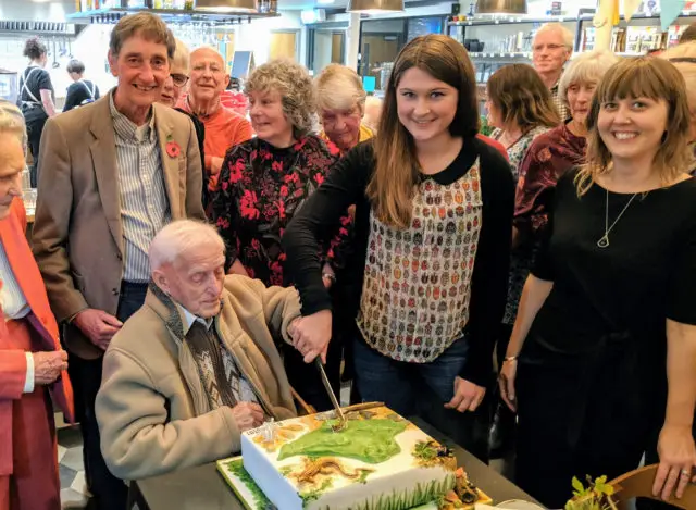 Bill Shepard 98 cuts the IWNHAS centenary cake with Natalie Bone 18 - the oldest and youngest members of the society