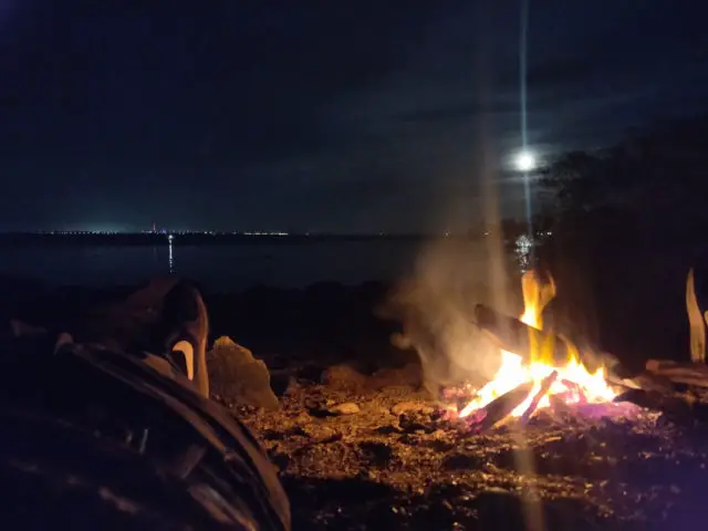 Harry and Charlie around the camp fire on the beach