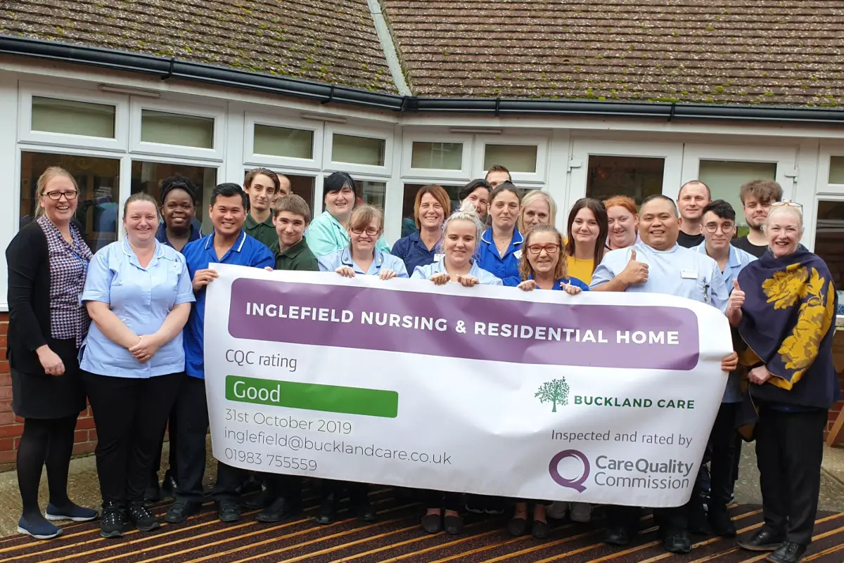 Staff from care home with giant CQC banner