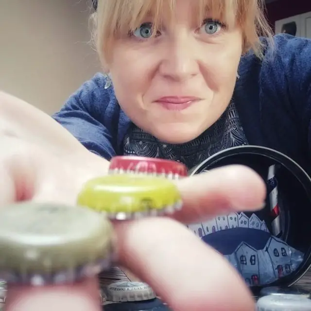 Lucy holding bottle tops