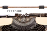 'postpone' written on a typewriter