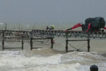 Men working on Totland Pier in the storm