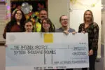 Members of the Phoenix Club holding a giant cheque
