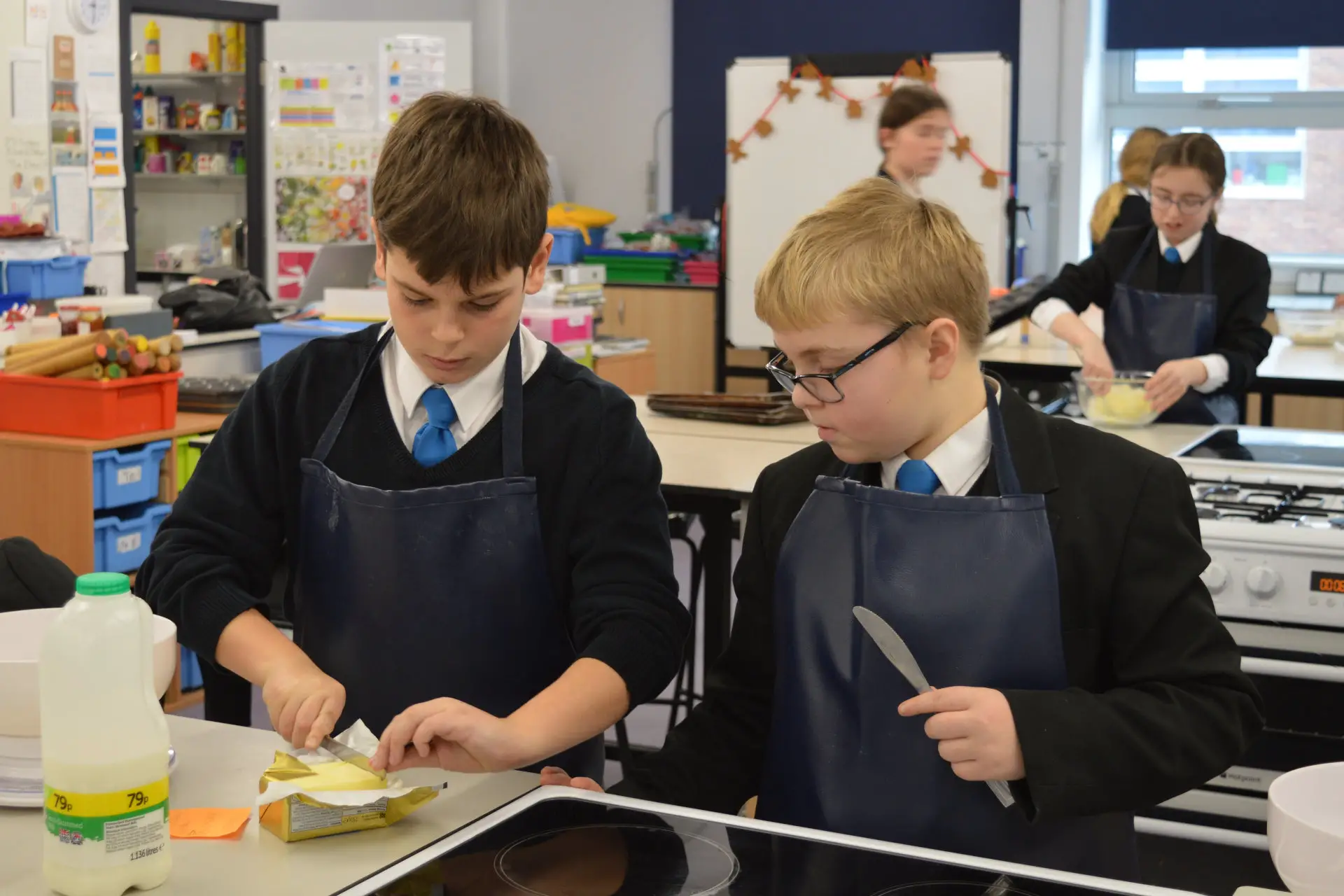 are Luca Patchett (age 12) and Lewey Way (11) - baking scones for the event