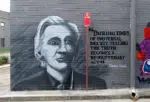 Mural of Julian Assange with a quote from George Orwell on a wall