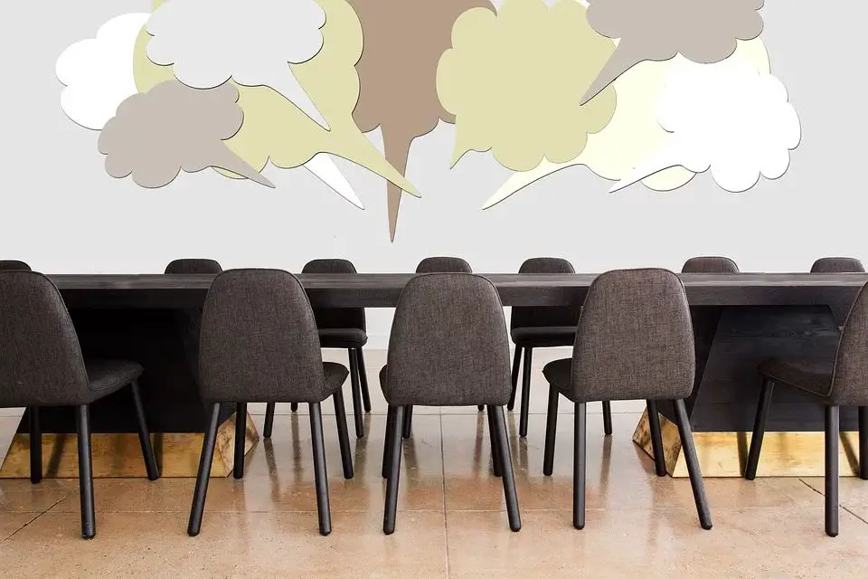 meeting table and chairs with speech bubbles