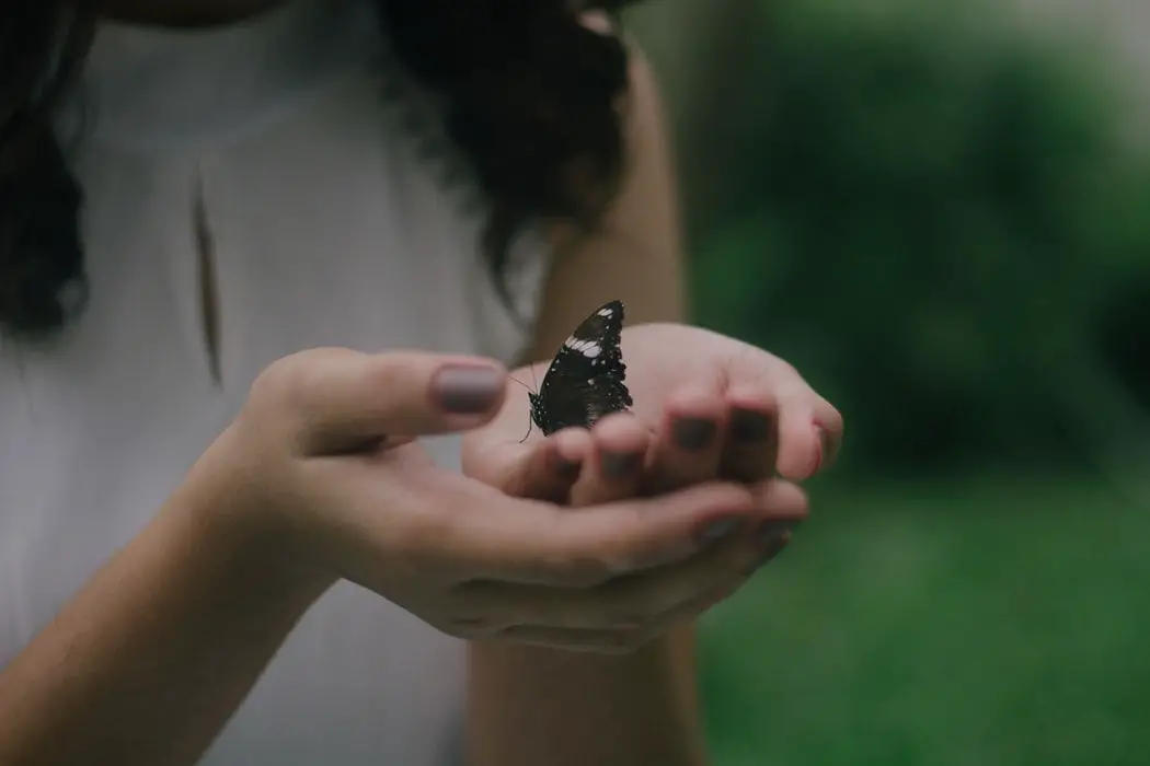 woman with butterfly in her hand