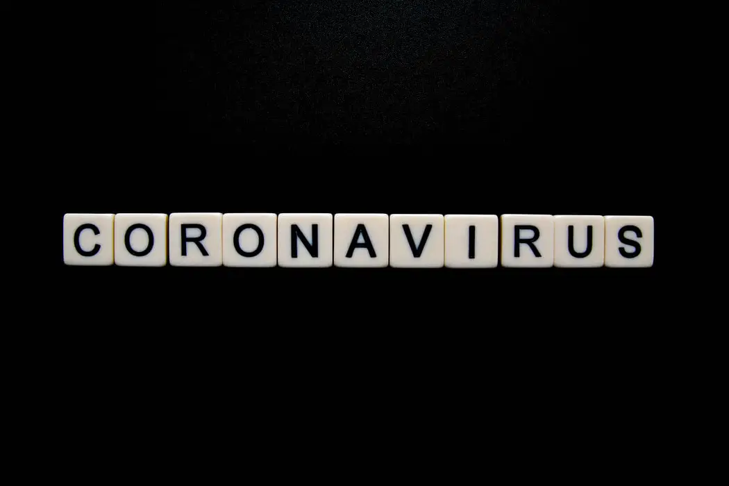 coronavirus spelled out with scrabble pieces