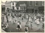 photo of people dancing in the street - 1940s