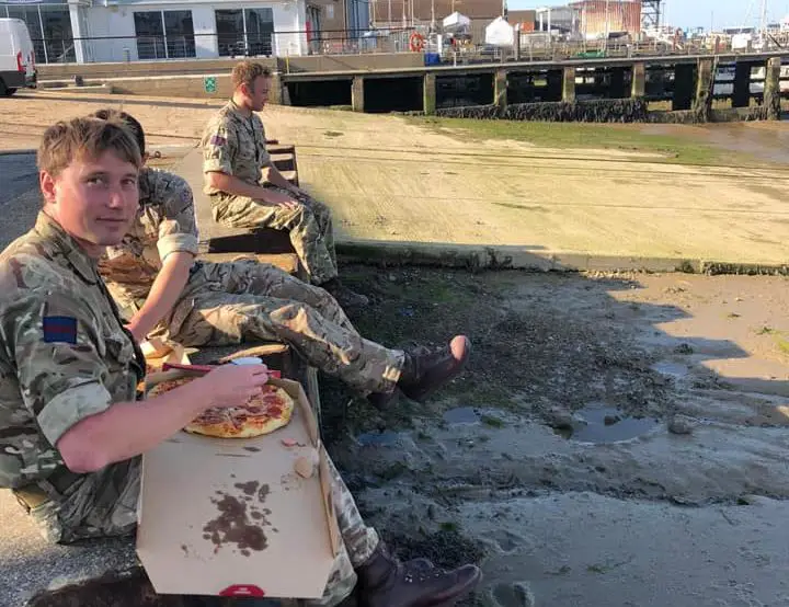 Scots Guards enjoying a pizza on their last night