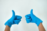 thumbs up in blue gloves
