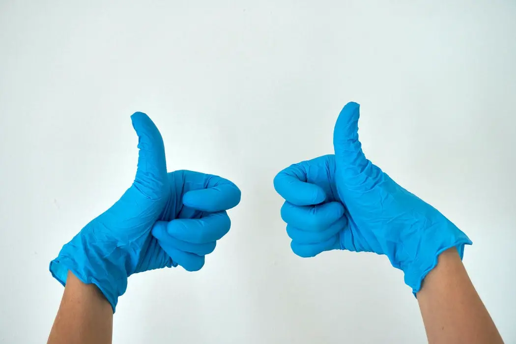thumbs up in blue gloves