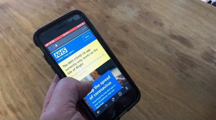 Person holding a mobile phone to download the contact tracing app