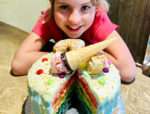 polly with her winning cake - showing the rainbow layers