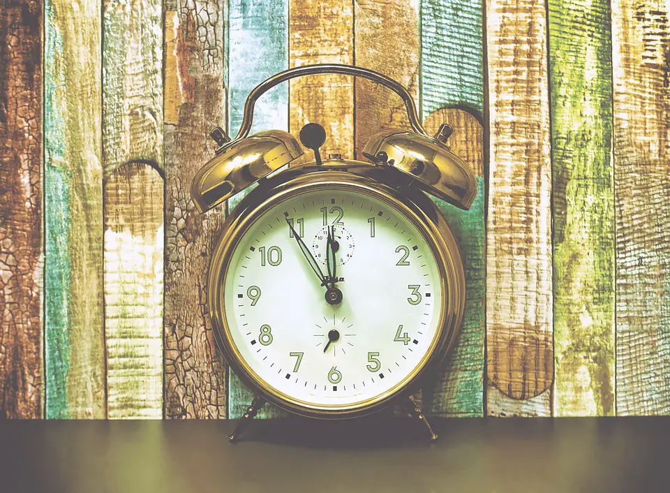 Alarm clock against wood background