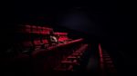 woman sitting alone in cinema by Karen Zhao