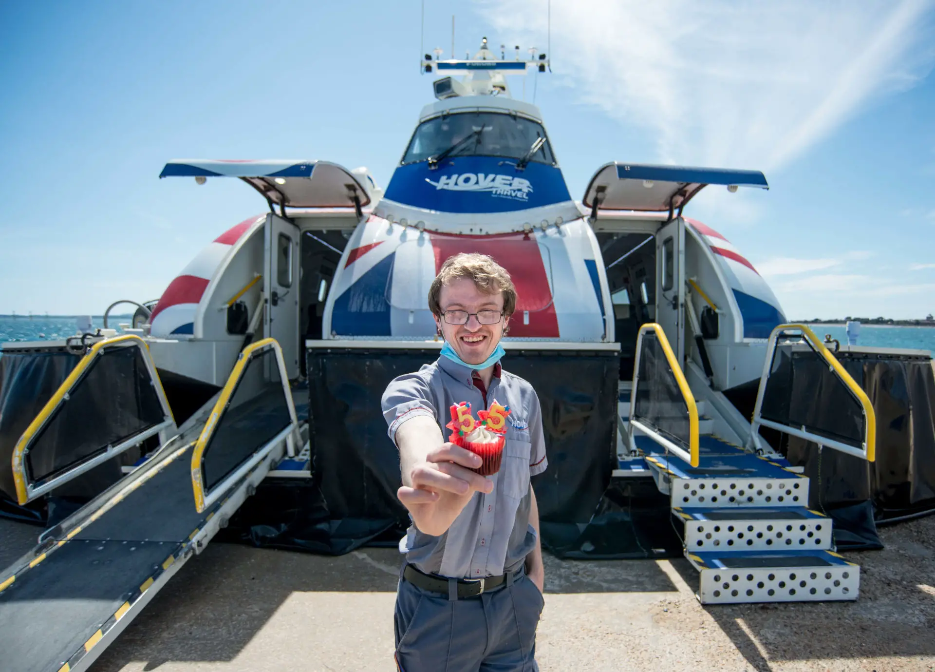 Staff member holding a cupcakes at the entrance of the Hovercraft