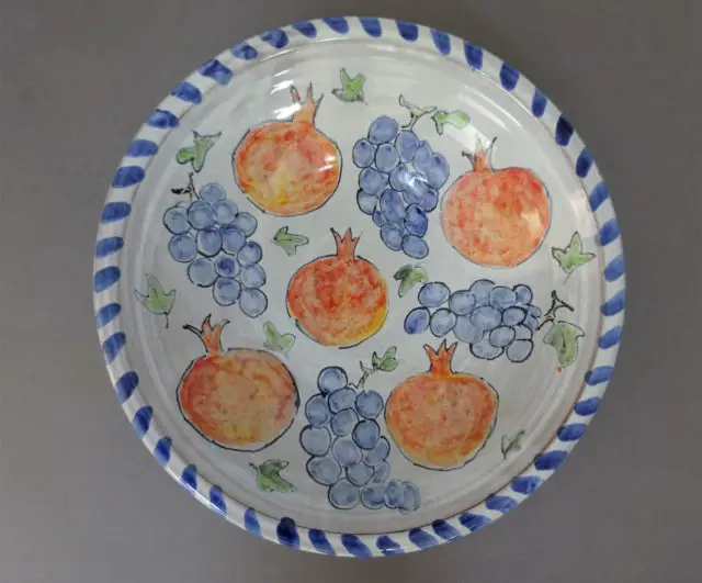 Plate by Molly Attrill showing pomegranates and grapes