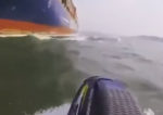 jetskier almost colliding with tanker