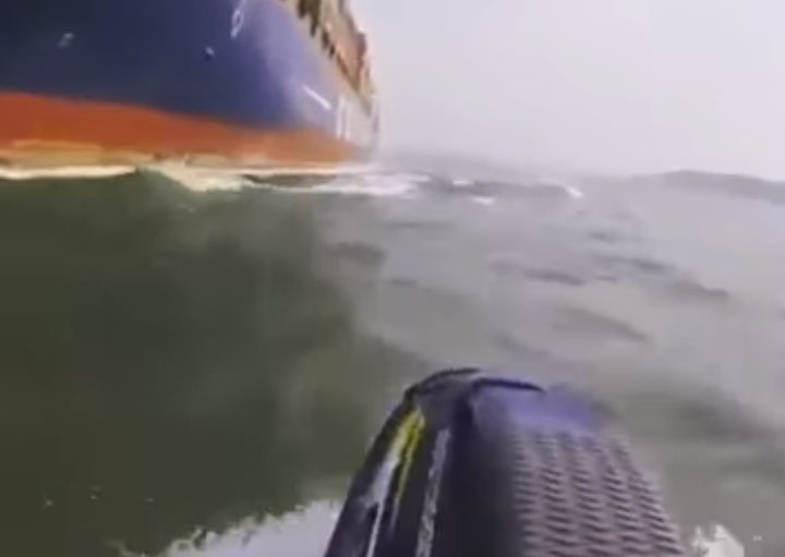 jetskier almost colliding with tanker