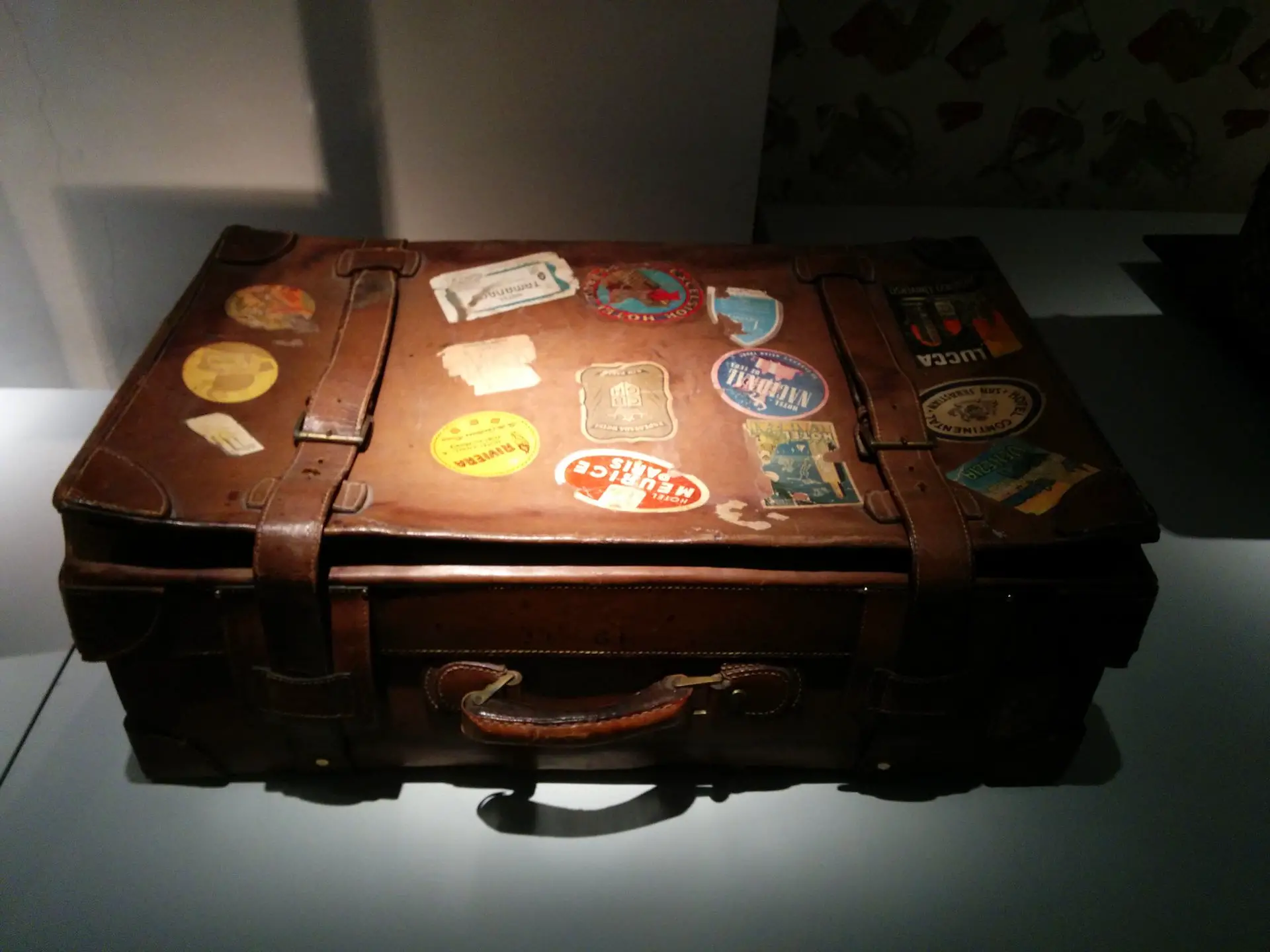 suitcase with travel stickers on it