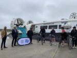 Cyclists and councillors standing by Hovercraft