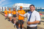 Beach ambassadors and Dave Stewart standing in front of Sandown Pier