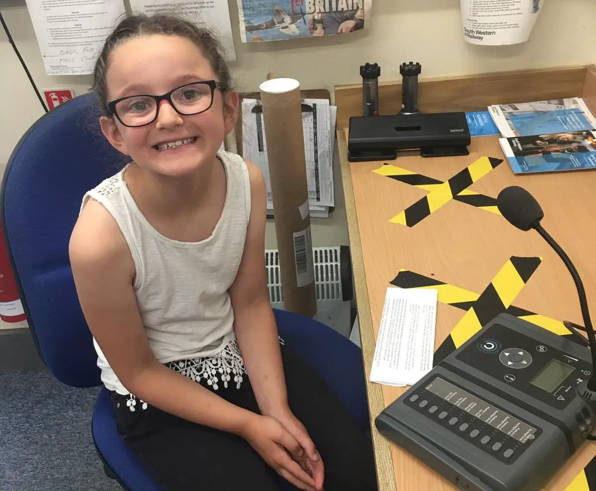 Evie sitting at the desk to record the announcement