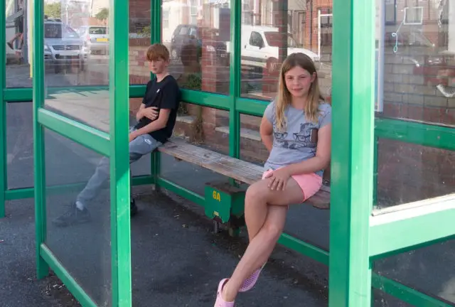 Cowes Enterprise College students at bus stop in Totland