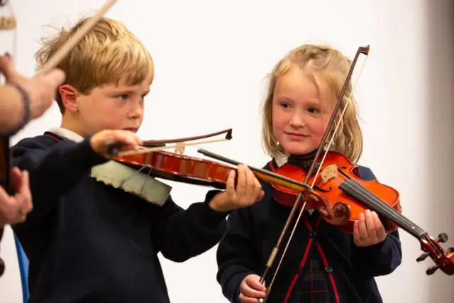 Primary School pupils learning to play the violin