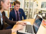 Sixth Form pupils on laptop in library