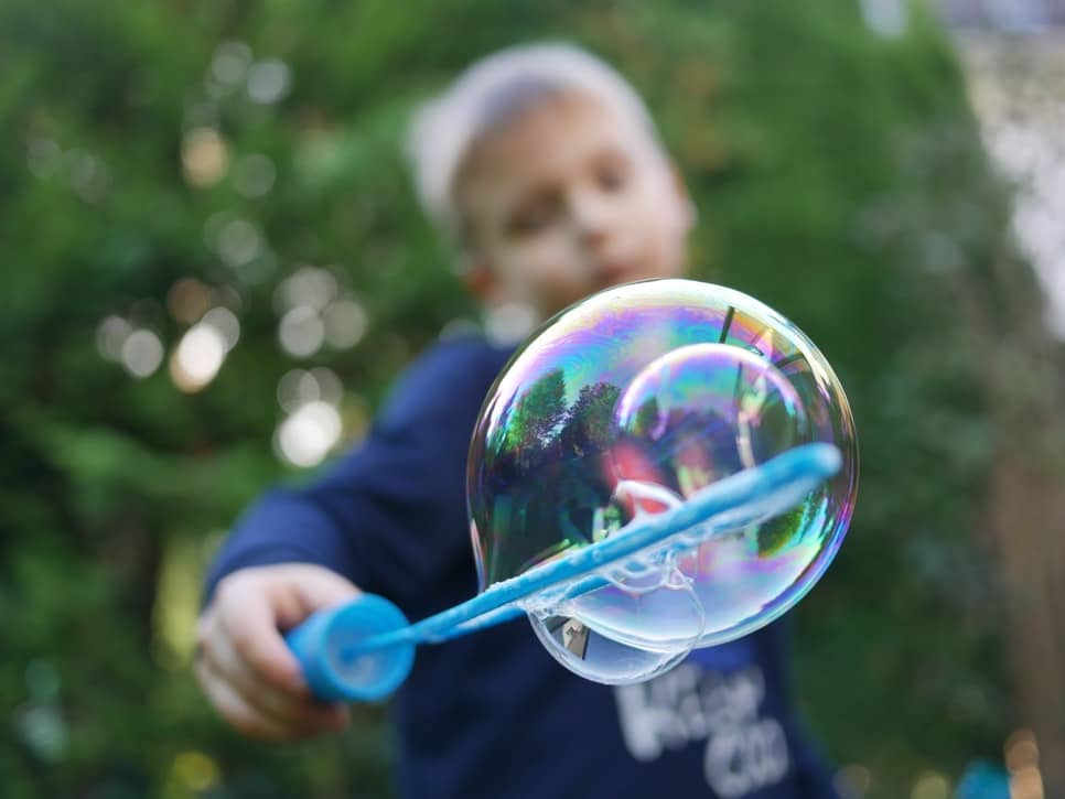 boy holding a bubble making