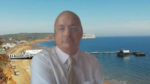 Cllr Ian Ward in online meeting, with Sandown pier in the background