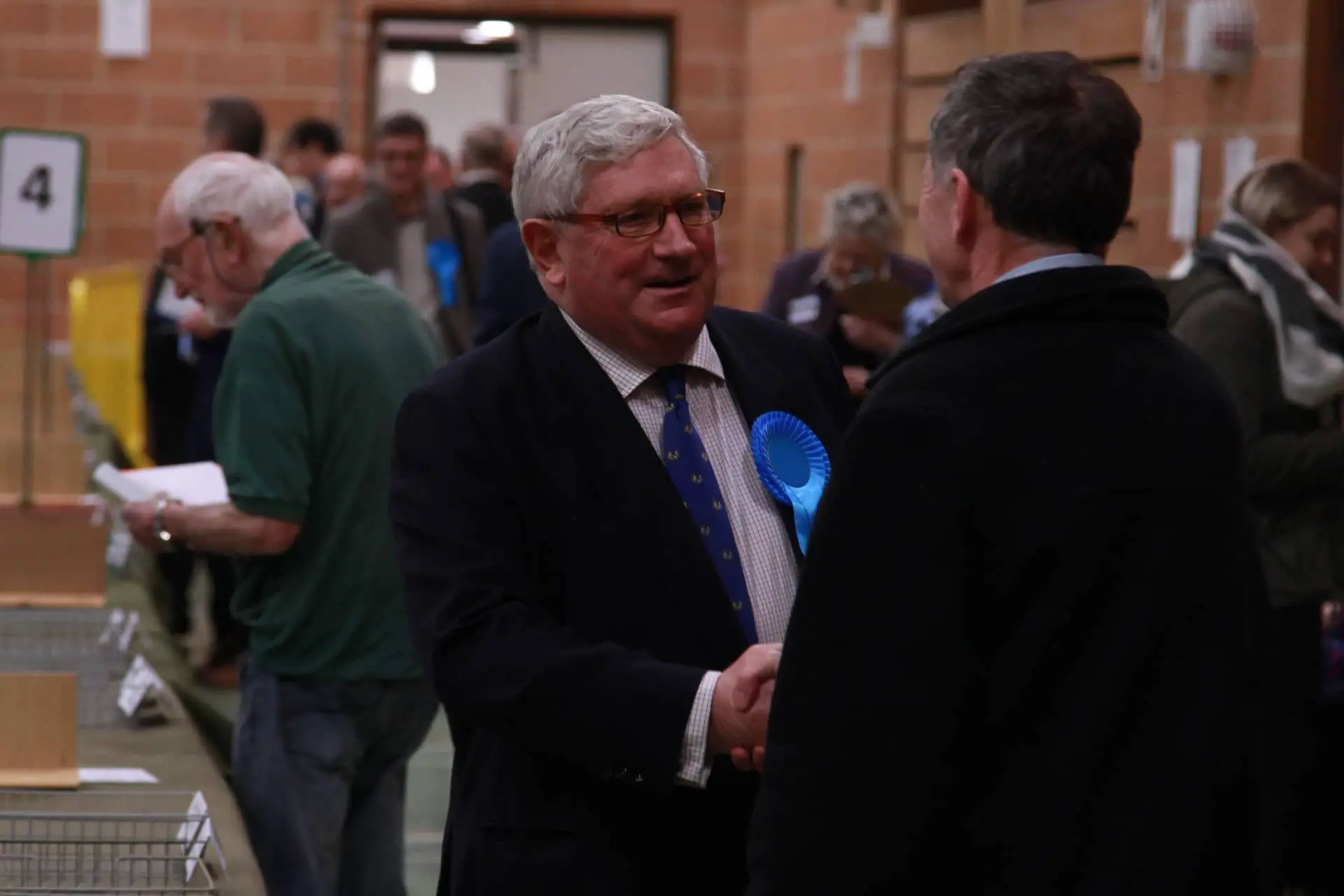 richard hollis shaking hands with nick stuart at the election count