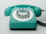 Teal coloured old style telephone