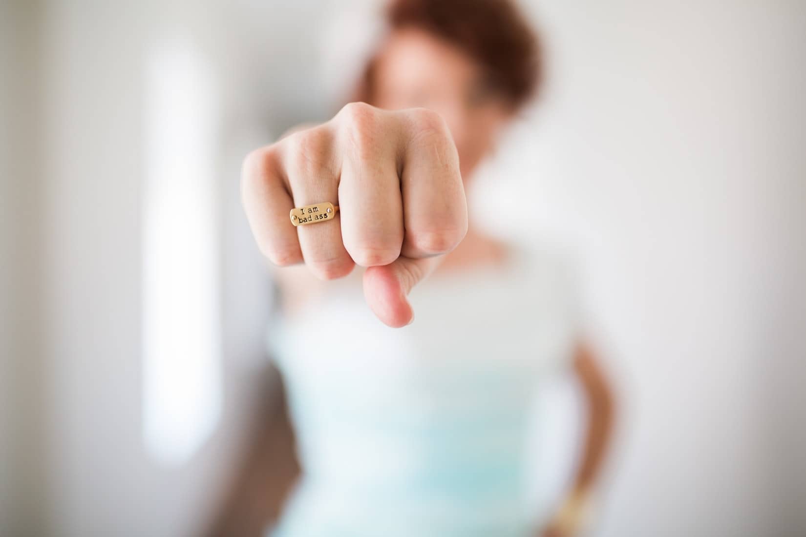 woman with ring that says 'I am badass'