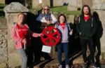 Handover of st catherines wheel in whitwell by those taking part in 21 hour walk around the Island