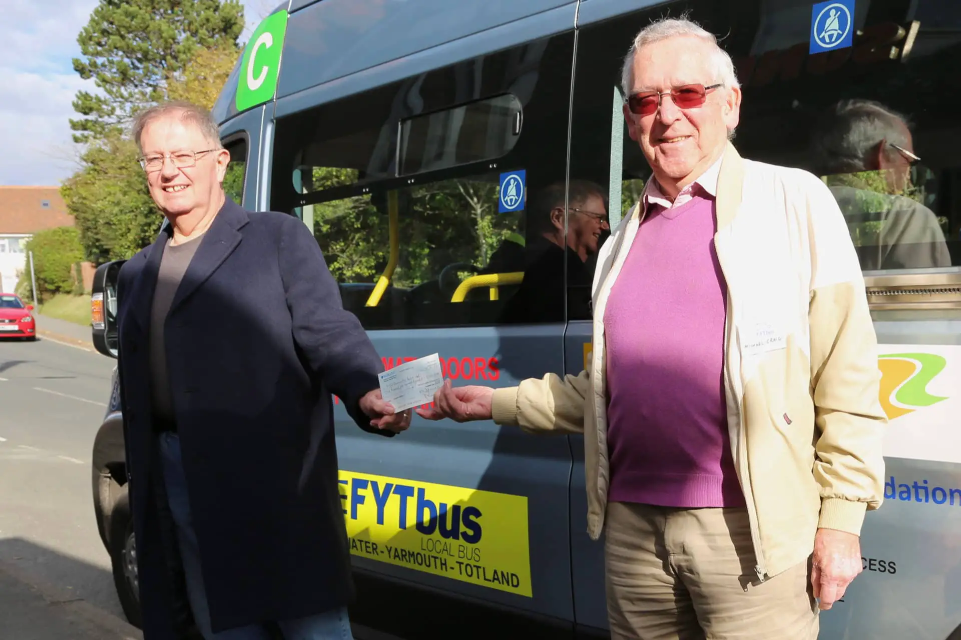 Needles Cheque being presented to FYT Bus