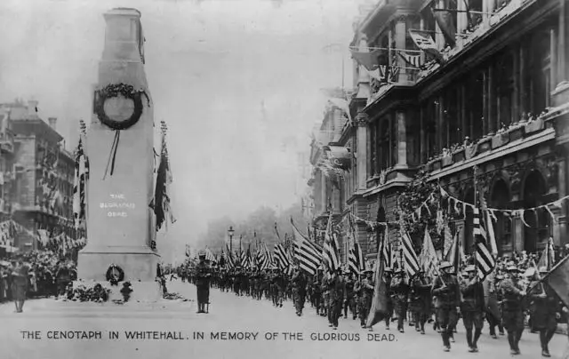 Saturday 19th July 1919. American troops march past the original wood and plaster Cenotaph carrying a job lot of American flags.
