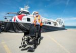 Hovertravel craft on forecourt with wheelchair in front of it